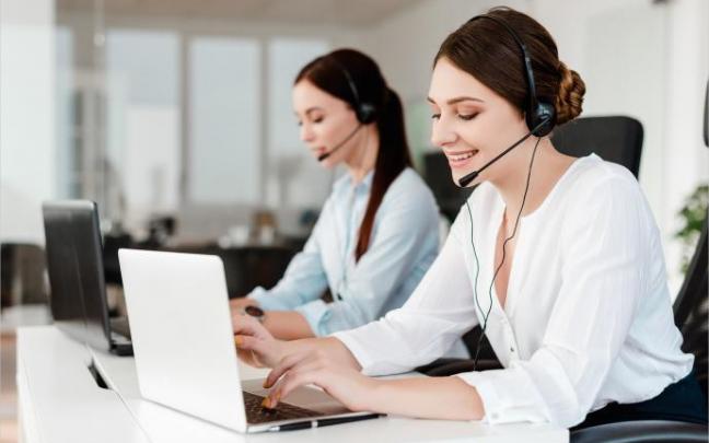 Dos teleoperadoras atienden llamadas de teléfono.