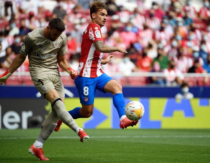 Unai Simón despeja un balón ante el acoso del francés Antoine Griezmann.