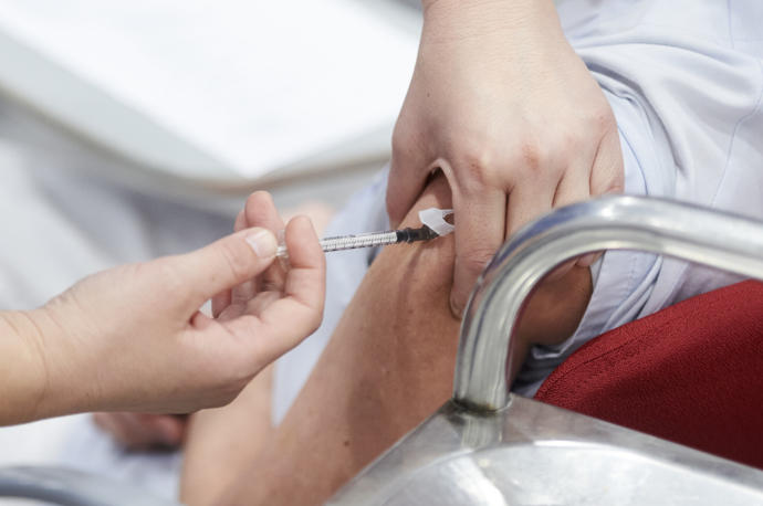 Una trabajadora sanitaria inyecta una vacuna contra el covid19