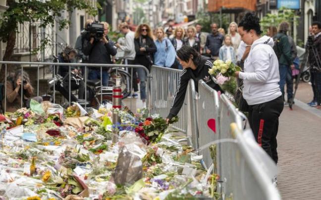 Un grupo de personas dejan flores en recuerdo del periodista asesinado. Un grupo de personas dejan flores en recuerdo del periodista asesinado.