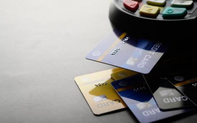 Varias tarjetas bancarias junto a un datáfono. Varias tarjetas bancarias junto a un datáfono.